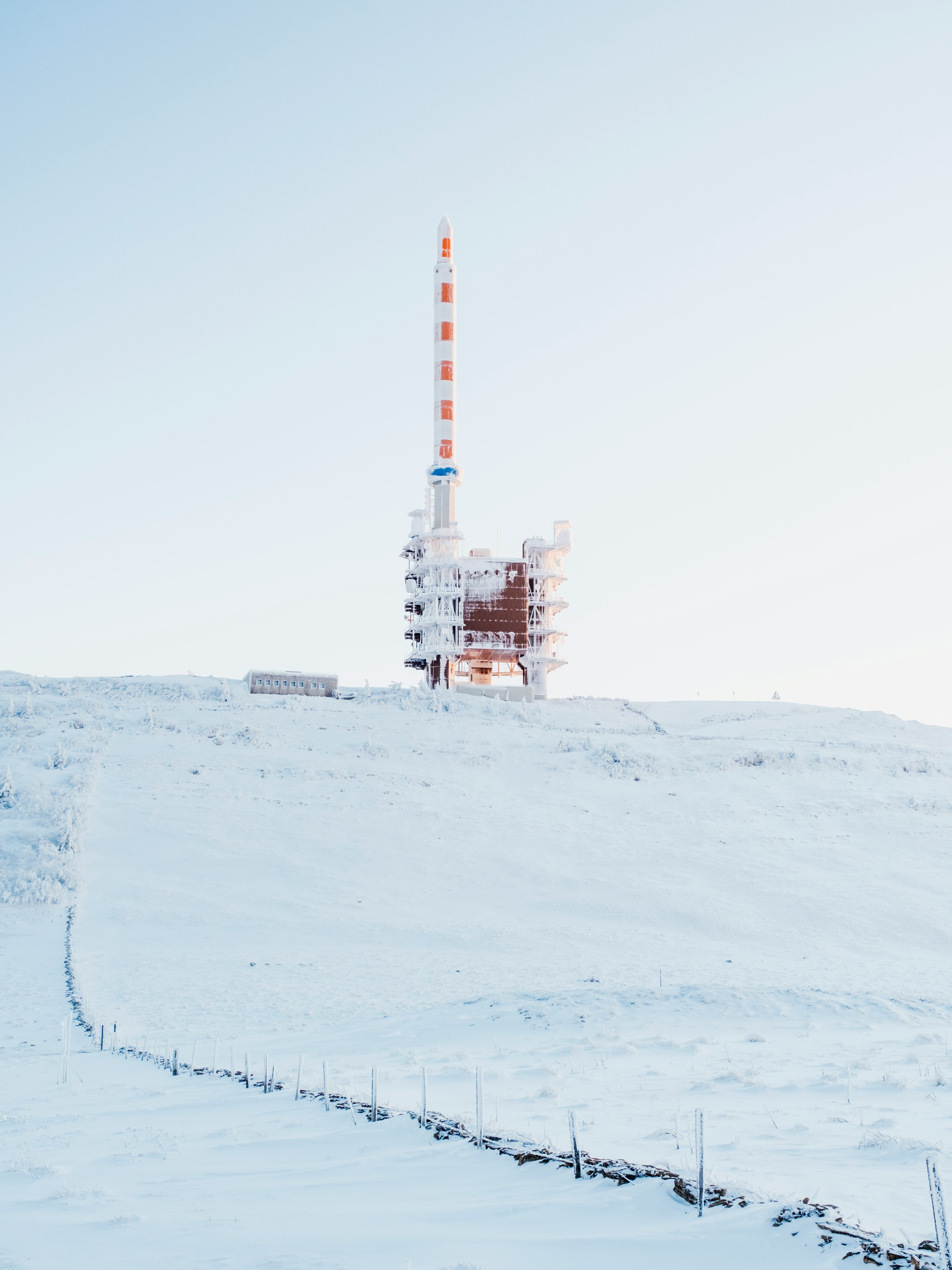 white and orange tower on white snow covered ground